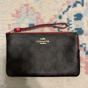 Coach wristlet with pink strap